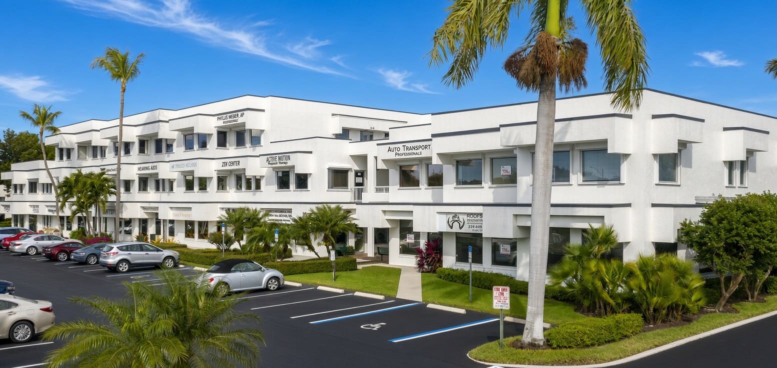North Trail Building, a white three-story office building at 1250 Tamiami Trail N, Naples, FL