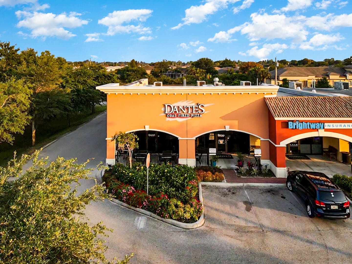 Street-level facade of Dante's Coal Fired Pizza and Brightway Insurance at Plaza del Sol, 900 SW Pine Island Rd, Cape Coral