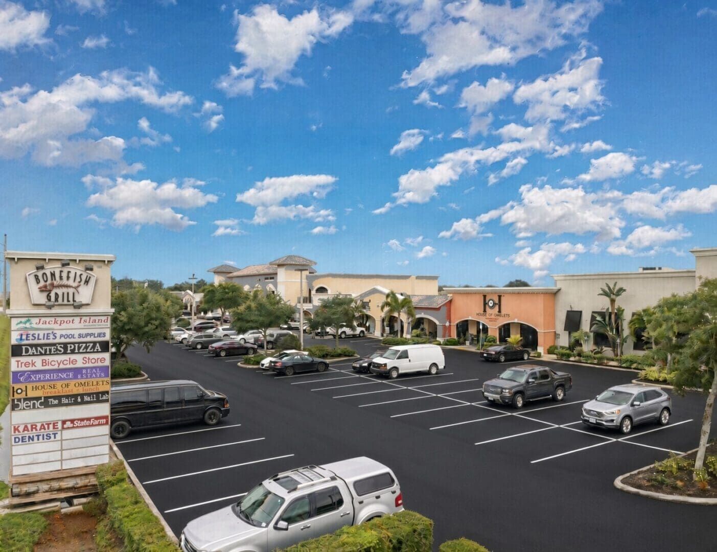 Aerial view of a Five Diamonds managed shopping center with a freshly sealed parking lot, Southwest Florida