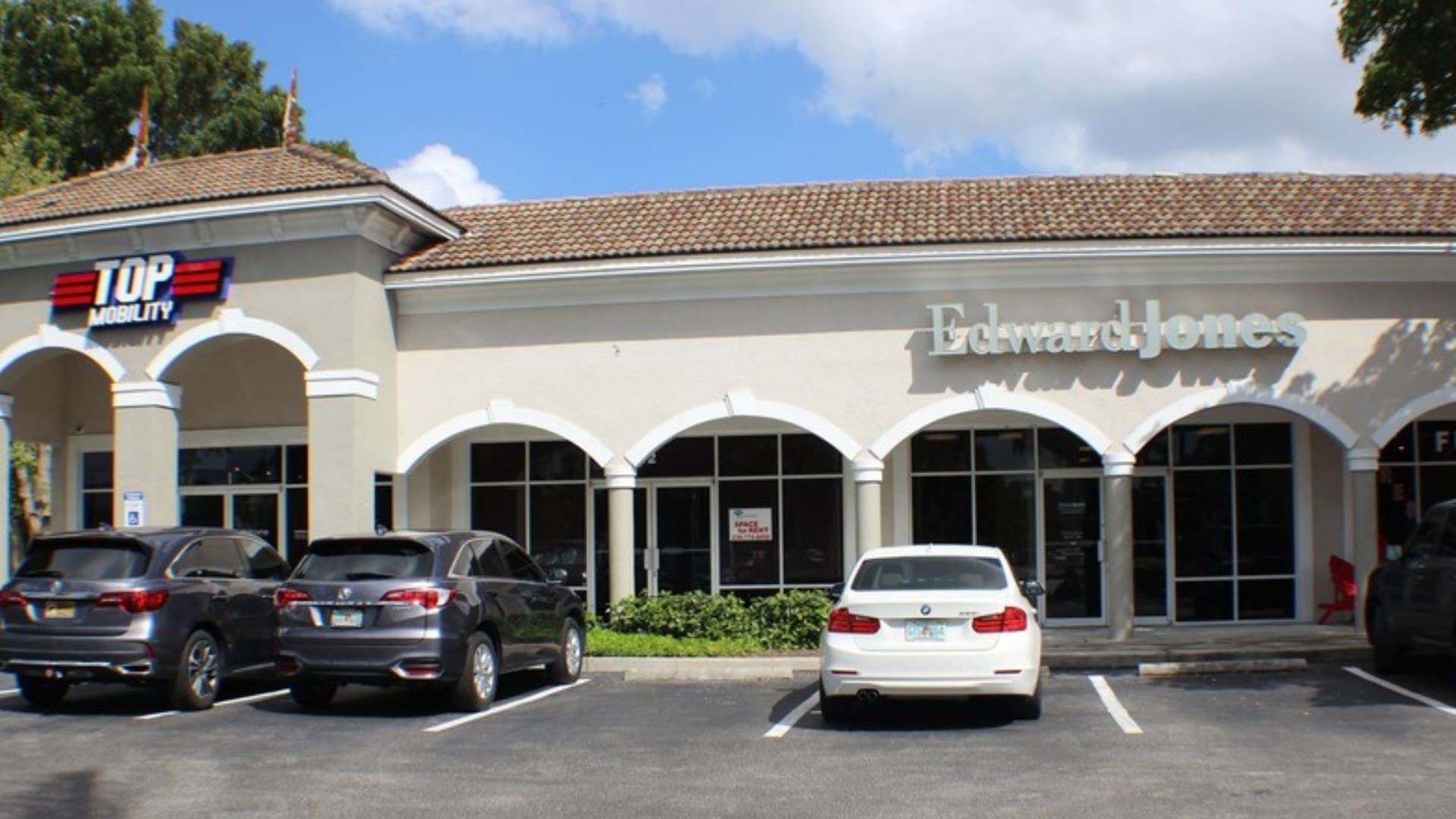 Arched storefronts and Edward Jones at Surroundings, 12980 Tamiami Trl N, Naples, FL